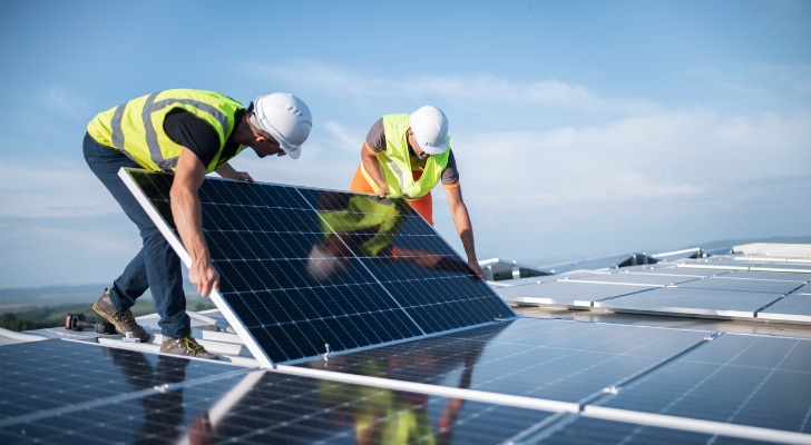 two engineers installing solar panels on 13